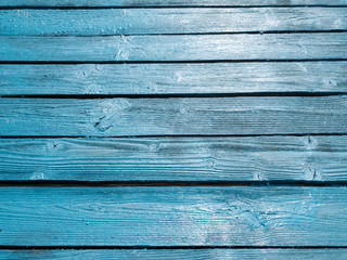 Wooden fence of blue boards. Boards blue. Blue wooden background.