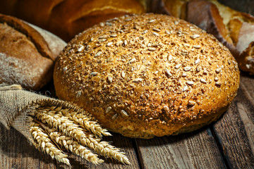 loaf of bread on wooden background, food closeup.Fresh homemade bread.French bread. Bread at leaven. Unleavened bread.Ciabatta bread.