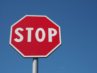 stop sign over blue sky