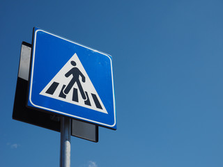 zebra crossing sign over blue sky