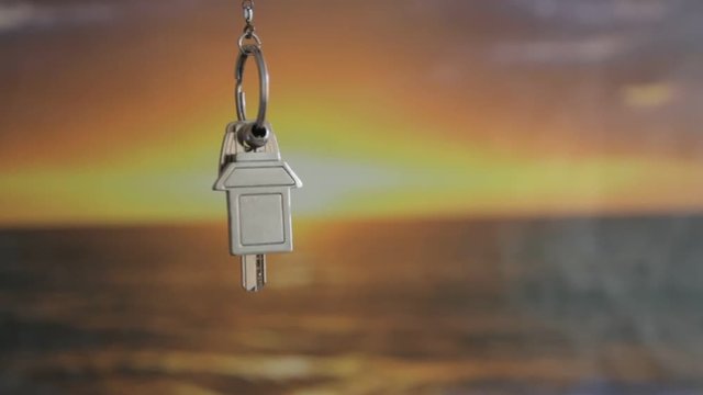 House keys with keychain rotate in the background