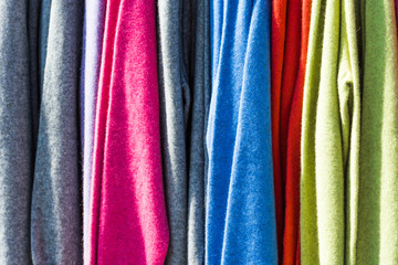 Pullovers hang on a hanger in the store, New Zealand. Close-up.