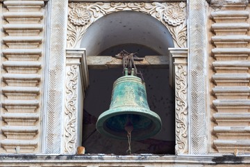 Obraz premium Isolated Green Bronze Bell on Tower of Spanish Catholic Church in Old City Antigua Guatemala
