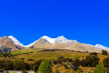 Mountain landscape of the Southern Alps, New Zealand. Isolated on blue background.