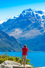 Man on the background of a mountain landscape, Southern Alps, New Zealand. Vertical. With selective focus.