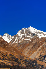 Mountain landscape of the Southern Alps, New Zealand. Vertical. Isolated on blue background.