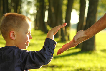  parent holds the hand of a small child