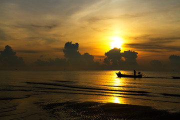Sunrise in the sea and fisherman on beach