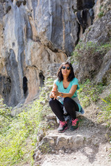 Young indian woman sitting in the mountain
