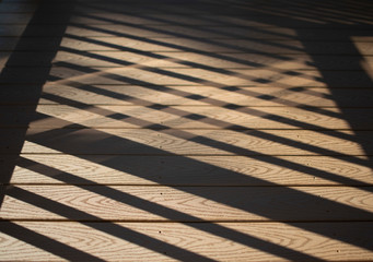 Criss-Cross Shadows of Railings on Porch Deck
