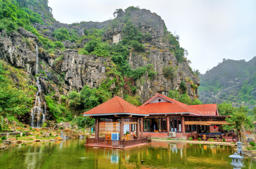 Fototapeta na wymiar Waterfall at Hang Mua Cave at Trang An, Vietnam