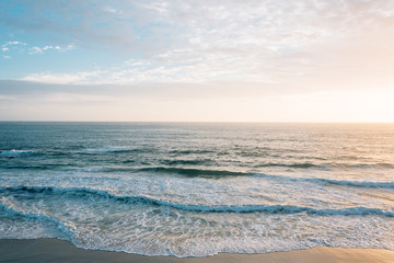 Fototapeta na wymiar Waves in the Pacific Ocean at sunset, in Laguna Beach, Orange County, California