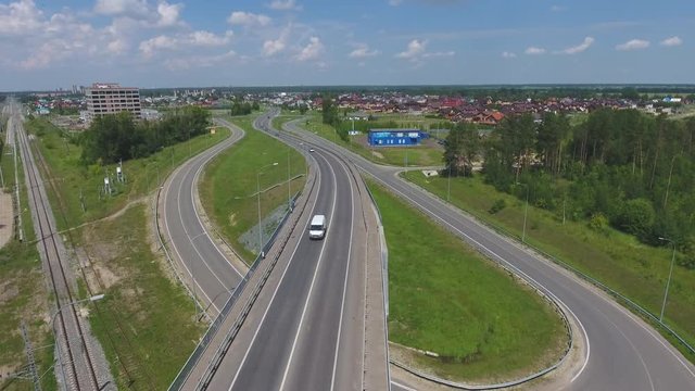 Transport interchange. Crossing the road. Top view of the road, city and forest. Summer video from the drone.