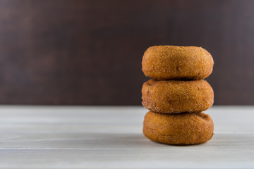 Fototapeta na wymiar Stack of Three Rustic Donuts