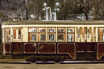 Old vintage tramway car on the night city street.