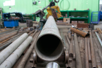 Round steel pipe in warehouse. Macro close up, selective focus