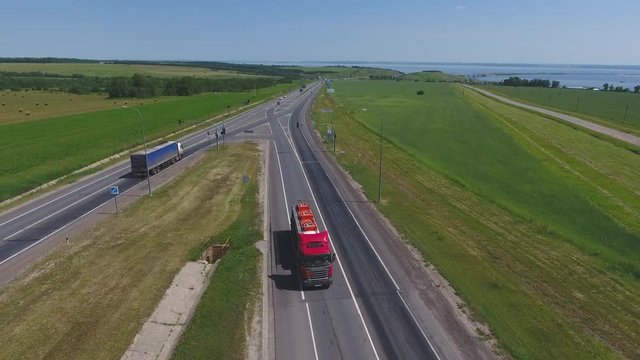 Transport interchange. The movement of cars on the road. Top view of the road and cars. Summer video from the drone. Rural landscape.