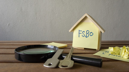 House or home model with text FSBO (For Sale by Owner). Property or real estate co