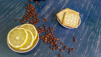 for Breakfast - coffee beans, lemon slices and biscuits crackers