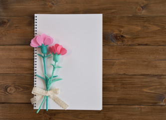 A sketchbook with flowers,carnations made of handmade used felt, on wooden background.(37-2）