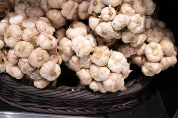 Fototapeta na wymiar Garlic bunch in basket for sale