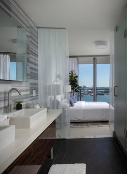 Miami apartment bathroom looking into bedroom with view of biscayne bay. 