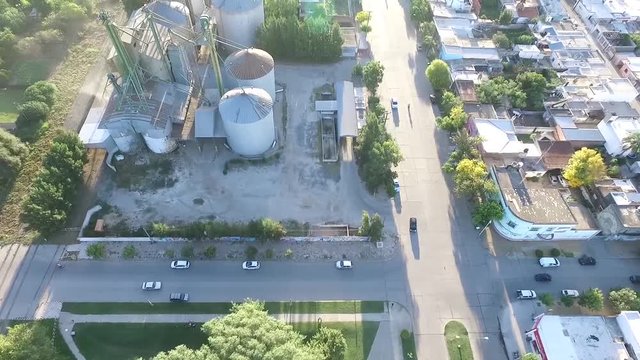 Drone Aerial top view of agriculture grain silos storage tank with a truck queue in the right because of harvest time