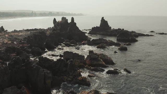 Aerial view rocks and stones on the Arambol beach in North Goa, India.