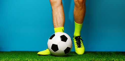 Soccer player with ball on the green grass.