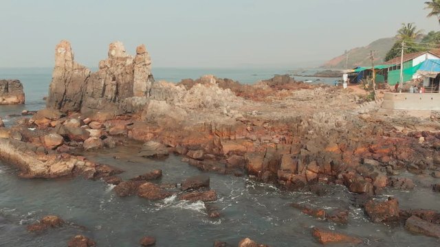 Aerial view rocks and stones on the Arambol beach in North Goa, India.