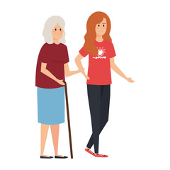 Obraz premium young woman volunteer helping a grandmother
