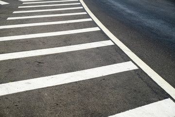 crosswalk on the road for safety when people walking cross the street, Pedestrian crossing on a repaired asphalt road, Crosswalk on the street for safety. 