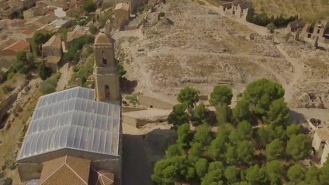 aerial image of the ancient city Corbera de Ebre with mountains in the background