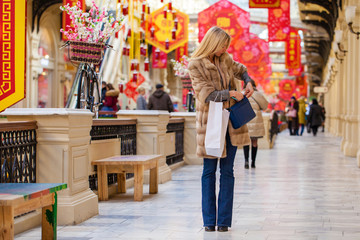 Obraz premium Young happy woman with some shopping bags in the mall