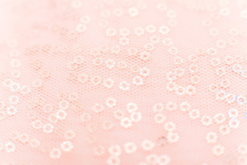 mesh fabric texture with sequins Texture cloth mesh. Pink shiny mesh fabric close-up. Beautiful and original background or texture.