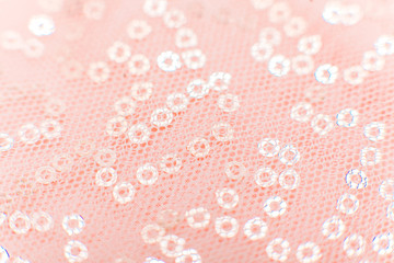 mesh fabric texture with sequins Texture cloth mesh. Pink shiny mesh fabric close-up. Beautiful and original background or texture.