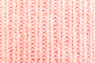 closeup of pink knitted fabric texture. facial loops. stockings with knitting needles and pink...