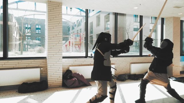 Swordsman fighting. Kendo practice. Duel sword combat training