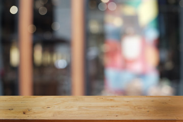 Empty dark wooden table in front of abstract blurred bokeh background of restaurant . can be used for display or montage your products.Mock up for space.