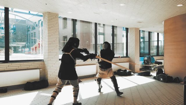 Swordsman fighting. Kendo practice. Duel sword combat training