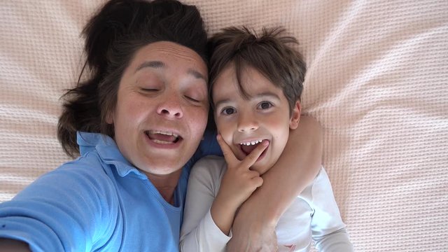 4K Selfie mother kisses her son and tells him a story