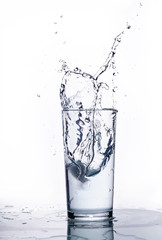 splash of water in a glass beaker. White background.