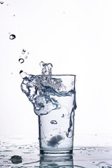 splash of water in a glass beaker. White background