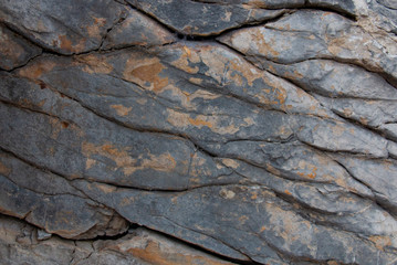 old stone wall in the cracks. texture of gray stone