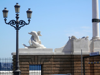 Sculpture and lantern at Cadiz harbour wall, Andalusia