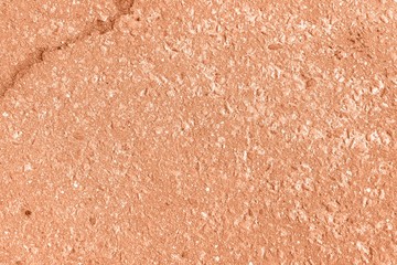 Old asphalt surface texture background close up. Orange color toned