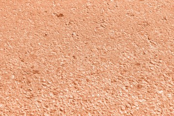 Old asphalt surface texture background close up. Orange color toned