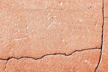 Old asphalt surface texture background close up. Orange color toned
