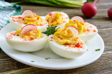 Deviled eggs. Delicious appetizer. Boiled eggs stuffed with yolk, mustard, mayonnaise, paprika. Classic recipe.