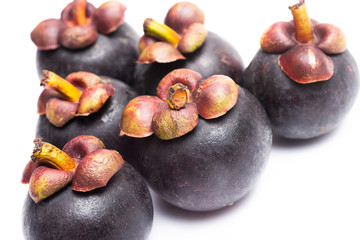 Group of mangosteen isolated on white background. Mangosteen is a queen of fruit in Thailand and asia fruit have a sweet. Fresh dark mangosteen background. Mangosteen is a popular fruit in Thailand.
